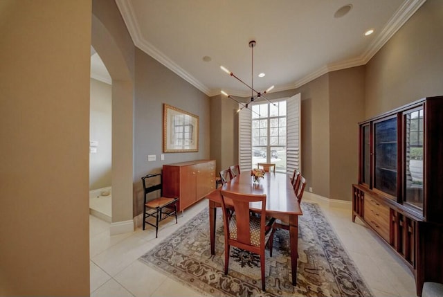 tiled dining room with a notable chandelier and crown molding