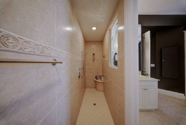 bathroom with vanity, tile patterned floors, and tiled shower