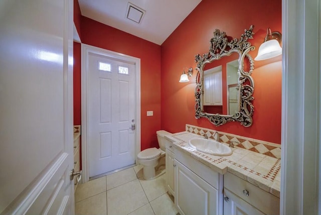 bathroom with tile patterned floors, vanity, and toilet