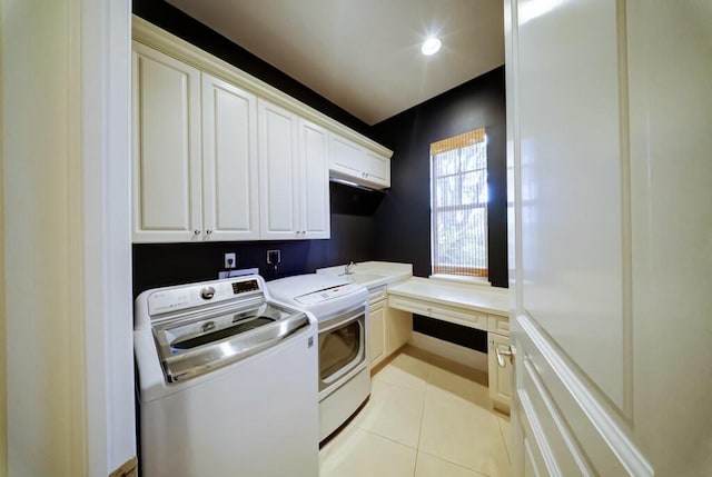 clothes washing area featuring cabinets, light tile patterned flooring, sink, and washing machine and clothes dryer