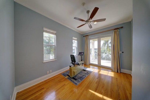 interior space with crown molding, french doors, ceiling fan, and light wood-type flooring