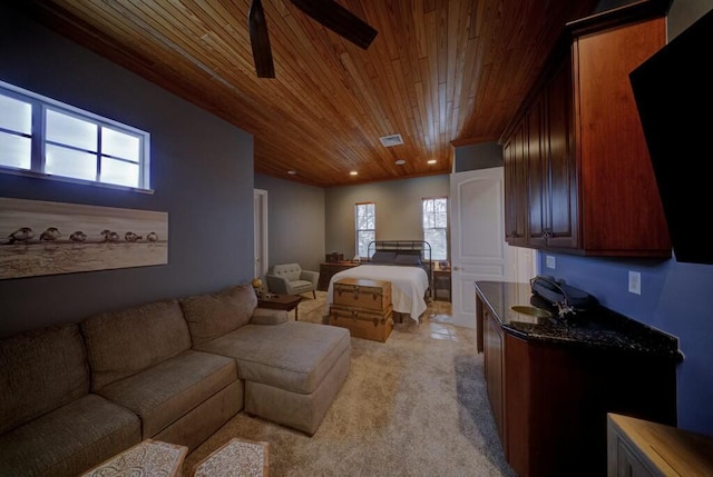 bedroom featuring multiple windows, light carpet, and wooden ceiling