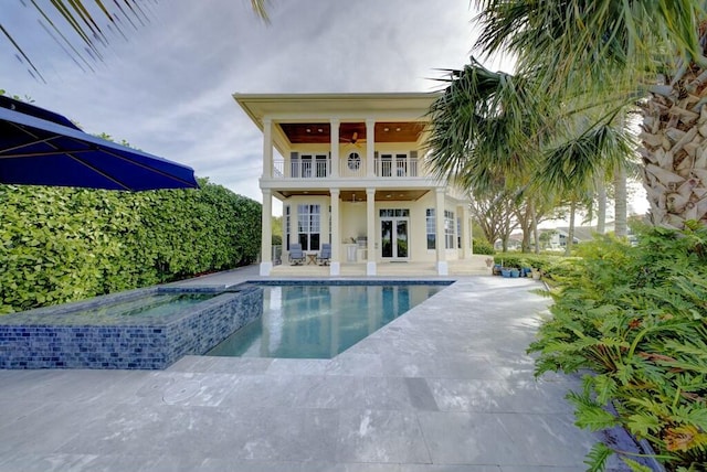 view of pool with french doors, an in ground hot tub, ceiling fan, and a patio area