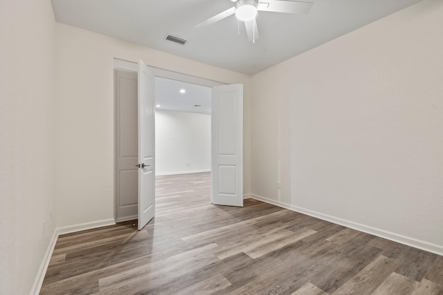 empty room featuring hardwood / wood-style flooring and ceiling fan