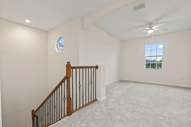 additional living space featuring ceiling fan and light colored carpet