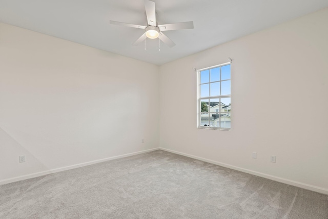 spare room with carpet and ceiling fan