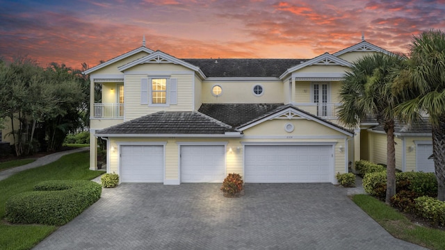 view of front of home featuring a garage and a balcony