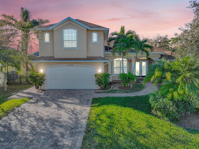 view of front of home with a lawn and a garage