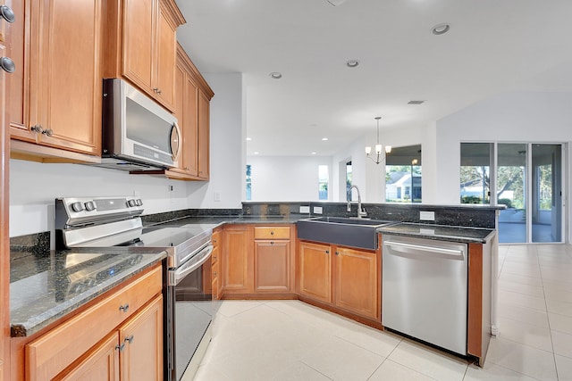 kitchen featuring kitchen peninsula, sink, appliances with stainless steel finishes, light tile patterned flooring, and pendant lighting