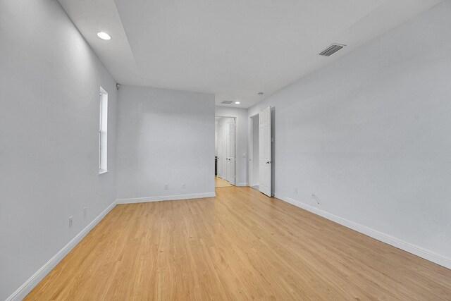 unfurnished room with light wood-type flooring