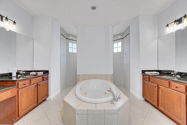 bathroom featuring tile patterned floors, plenty of natural light, plus walk in shower, and vanity