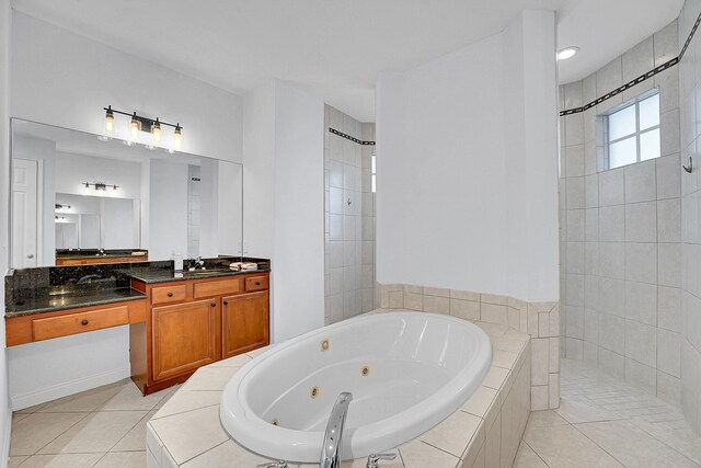 bathroom with tile patterned flooring, vanity, and plus walk in shower