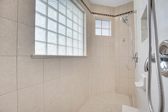 bathroom with tiled shower