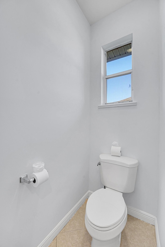 bathroom with toilet and tile patterned flooring