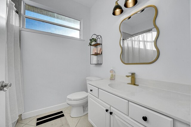 bathroom featuring toilet, vanity, and tile patterned floors