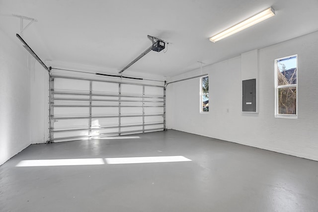 garage featuring electric panel and a garage door opener