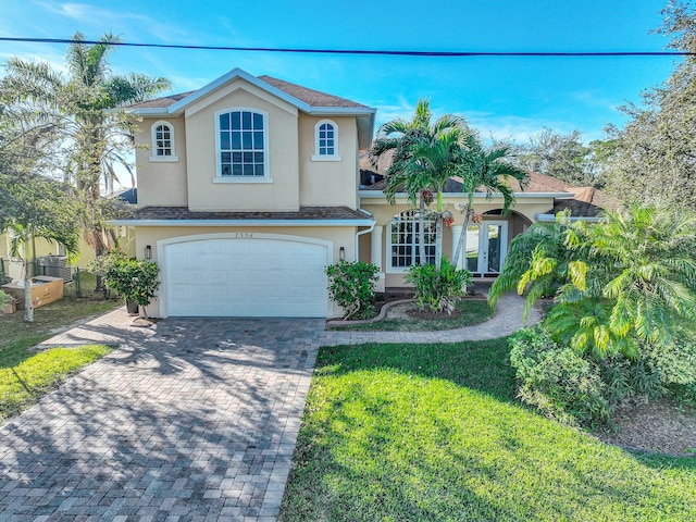 view of front of home with a garage and a front yard