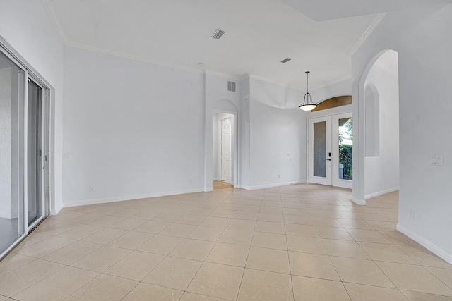 tiled empty room with french doors and ornamental molding