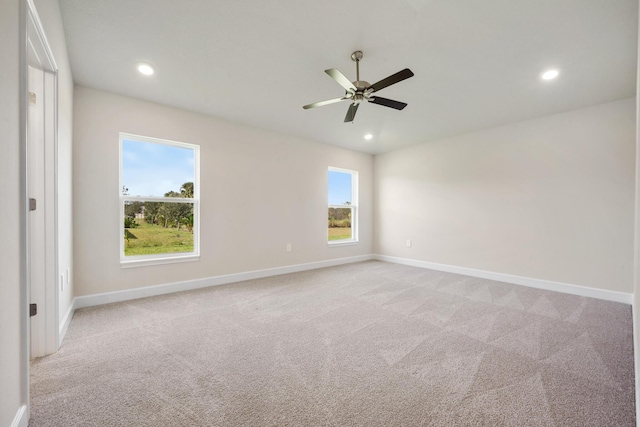 carpeted spare room featuring ceiling fan