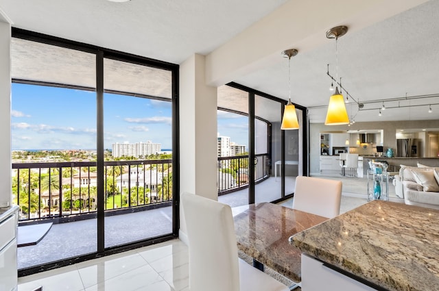 dining area with floor to ceiling windows