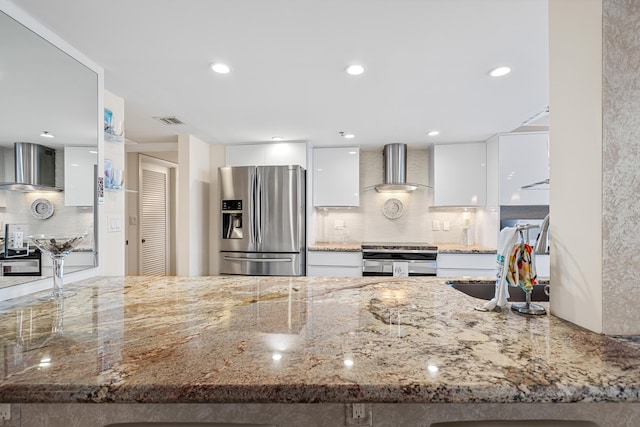 kitchen with modern cabinets, wall chimney exhaust hood, white cabinetry, and stainless steel appliances