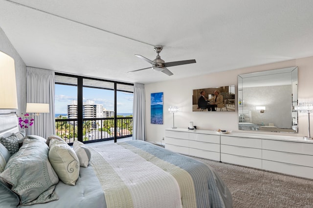 bedroom with a ceiling fan, a textured ceiling, floor to ceiling windows, access to outside, and carpet flooring
