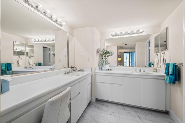 full bathroom featuring marble finish floor, baseboards, and vanity
