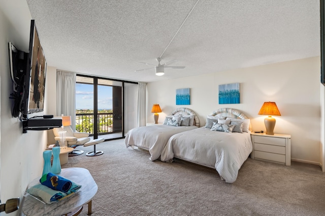 carpeted bedroom with expansive windows, a textured ceiling, a ceiling fan, and access to exterior