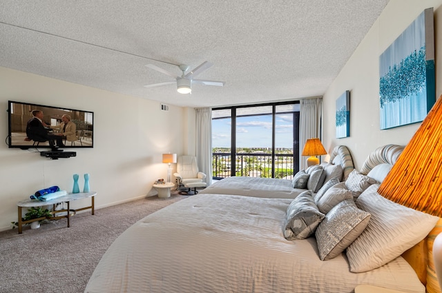 carpeted bedroom with floor to ceiling windows, access to exterior, visible vents, a textured ceiling, and ceiling fan