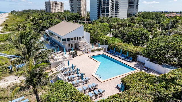 pool with stairway, a patio area, and fence