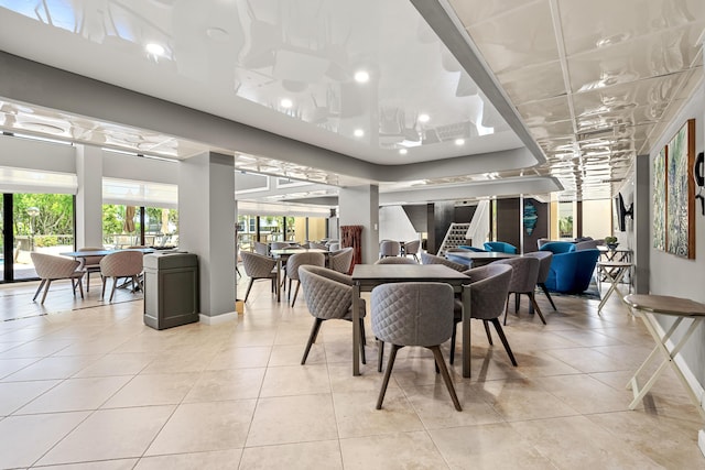 dining area featuring light tile patterned flooring, baseboards, stairs, and recessed lighting
