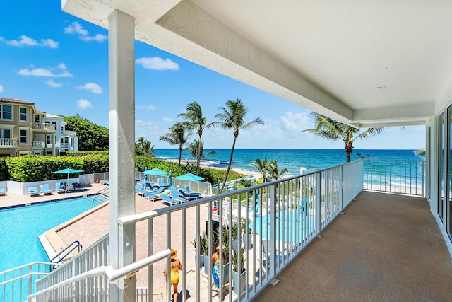 balcony featuring a beach view and a water view