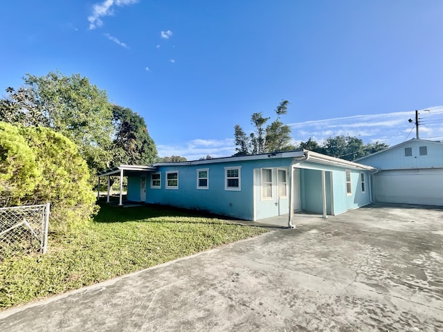 back of property featuring a yard, a garage, and an outdoor structure