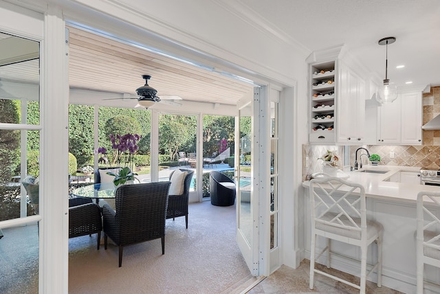 interior space with ceiling fan, ornamental molding, and sink