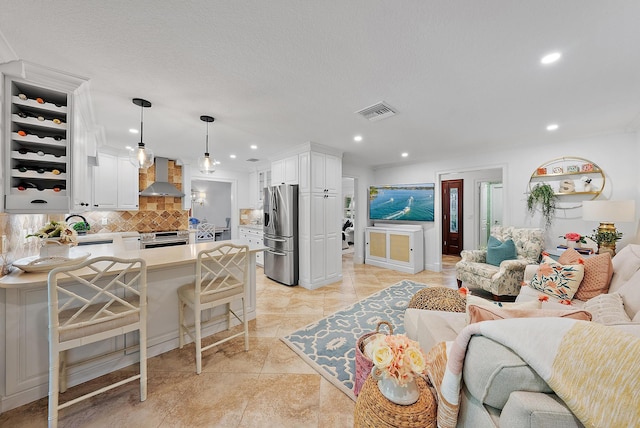 living room featuring light tile patterned flooring and a textured ceiling