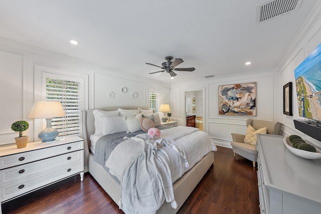 bedroom featuring dark hardwood / wood-style flooring, ceiling fan, and ornamental molding