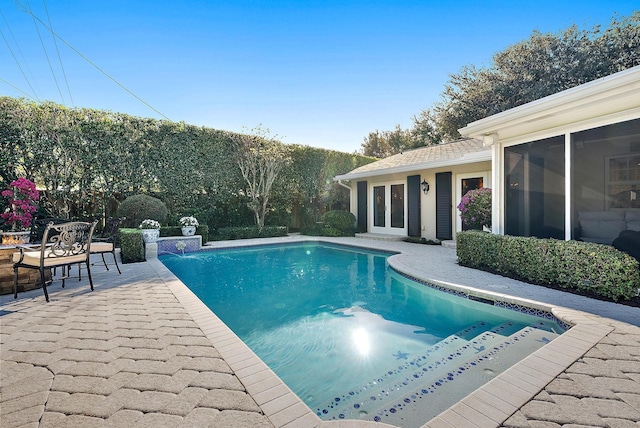 view of swimming pool with a patio area