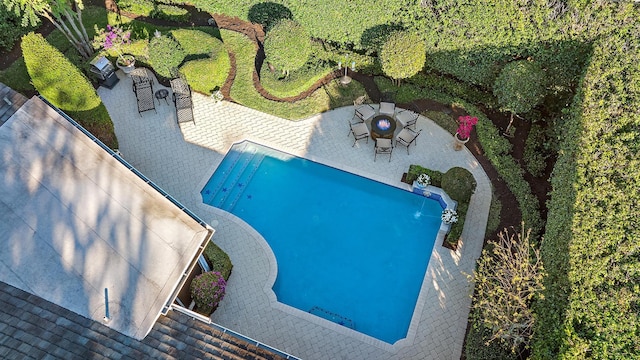 view of pool with a patio and an outdoor fire pit