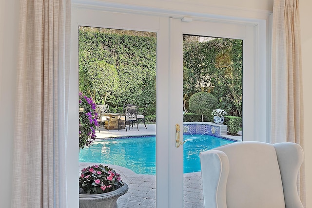 view of pool featuring a patio, pool water feature, and a fire pit