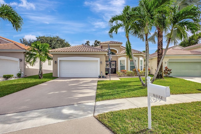 mediterranean / spanish-style home featuring a garage and a front lawn