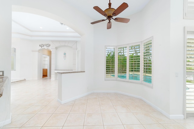 tiled spare room with ceiling fan