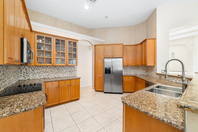 kitchen featuring stone counters, sink, light tile patterned floors, tasteful backsplash, and stainless steel appliances