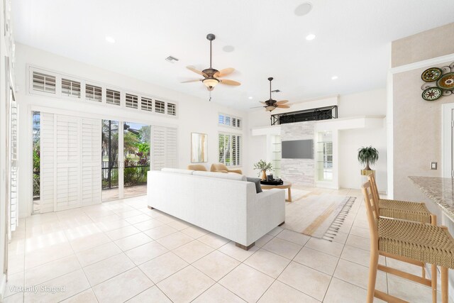 tiled living room with ceiling fan