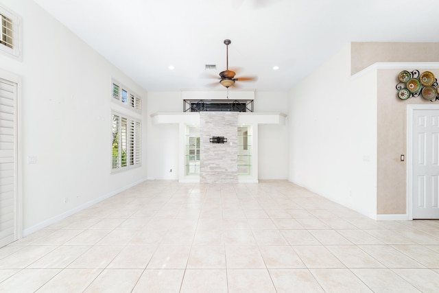 unfurnished living room with ceiling fan and light tile patterned floors