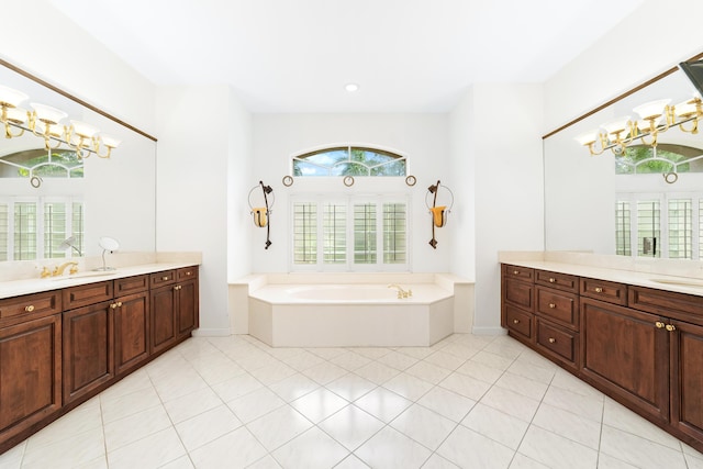 bathroom featuring tile patterned floors, a bathtub, vanity, and an inviting chandelier