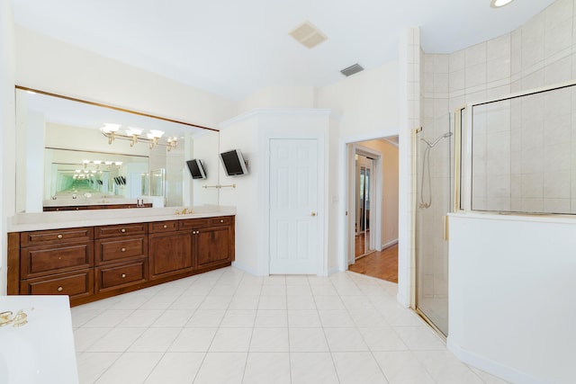 bathroom featuring vanity, a notable chandelier, and walk in shower