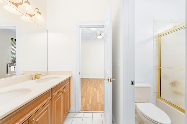 full bathroom with ceiling fan, enclosed tub / shower combo, tile patterned floors, toilet, and vanity