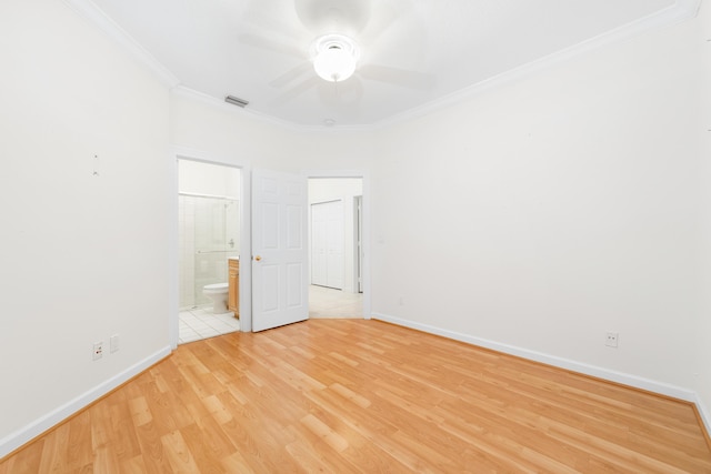 unfurnished bedroom featuring connected bathroom, ceiling fan, light hardwood / wood-style flooring, and crown molding