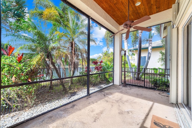 unfurnished sunroom featuring ceiling fan