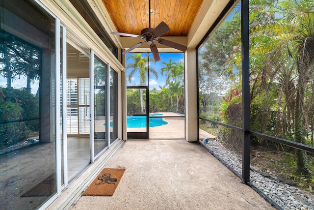 unfurnished sunroom with a wealth of natural light, ceiling fan, and wooden ceiling